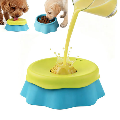 Colorful pet toy with a yellow liquid being poured into it, with two dogs eating from blue bowls in the background.