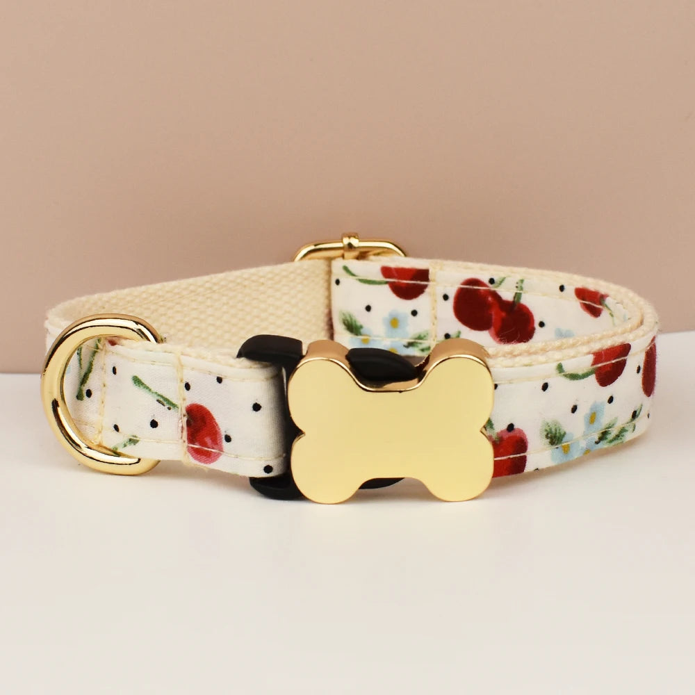 Dog collar with floral pattern and gold bone-shaped buckle on a beige background