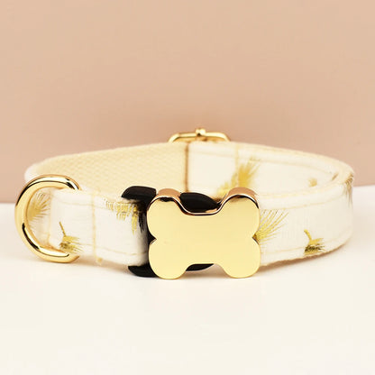 Dog collar with gold bone-shaped tag on a beige background