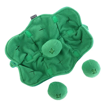 Green plush toy with two balls on a white background