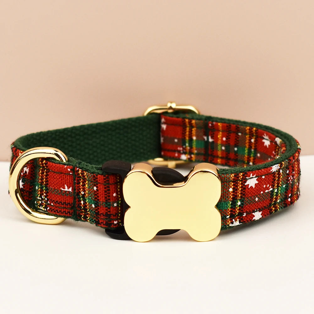 Plaid dog collar with gold bone-shaped tag on a beige background