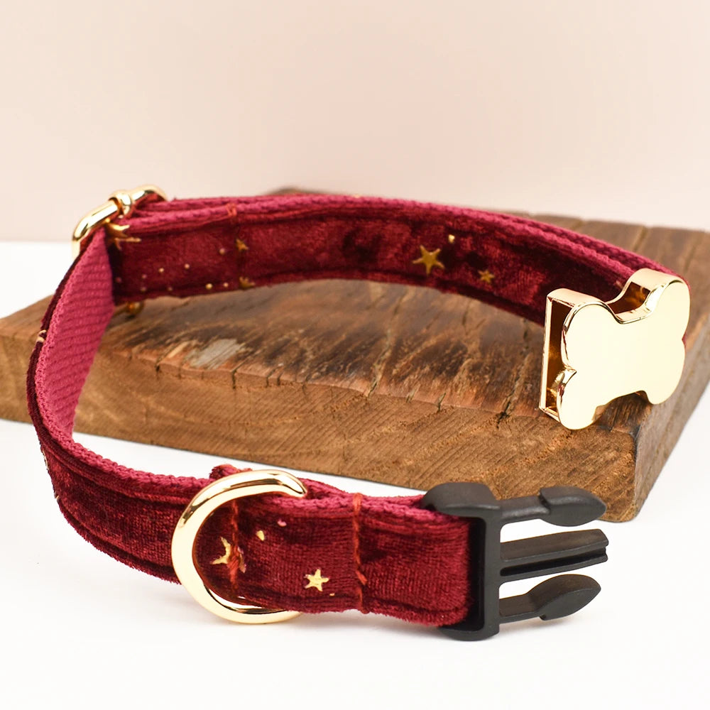 Red dog collar with gold hardware on a wooden block