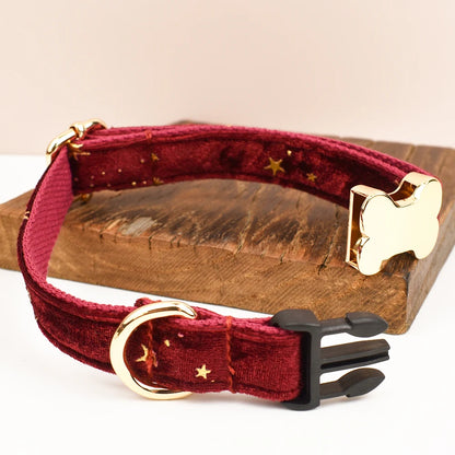 Red dog collar with gold hardware on a wooden block