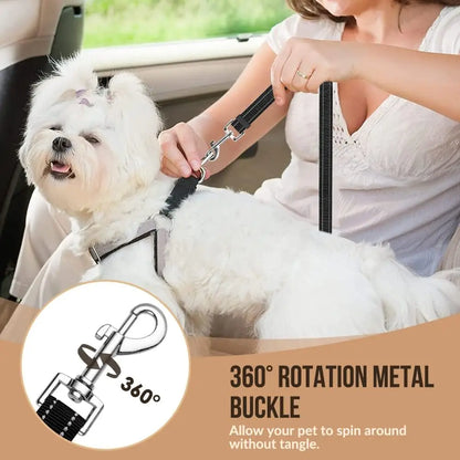 Woman sitting in a car with a small white dog on a leash, emphasizing the 360-degree rotation metal buckle feature.