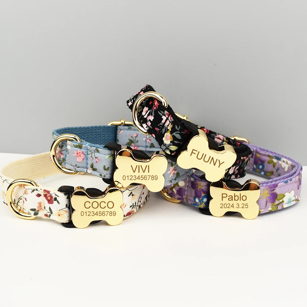 Four floral-patterned dog collars with gold name tags on a gray background
